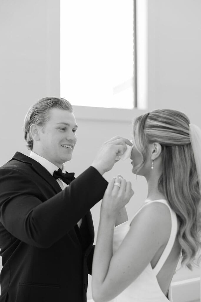 a black and white first look photo with bride and groom